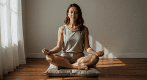 a woman sits on a meditation pillow eyes closed meditating