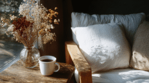 a cozy corner with couch and endtable with tea and dried flowers